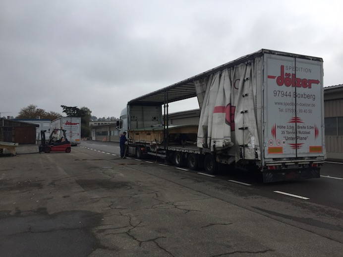 The first packed truck is waiting further down the street. The ride starts when the boxes are stowed in the second truck.