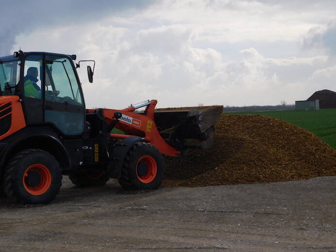 A wheel loader delivers the waste material