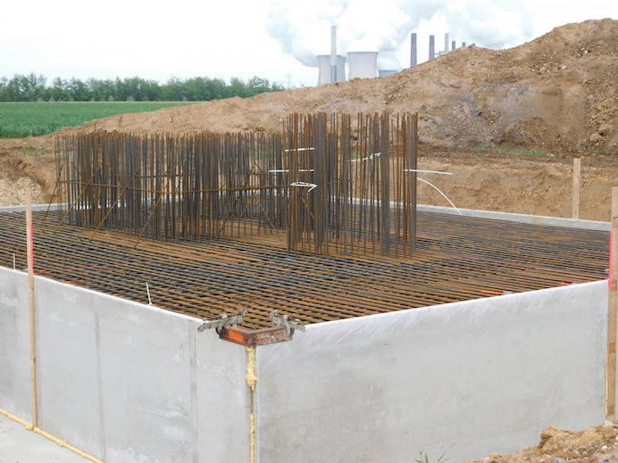 This pedestal is ready and waiting for the concrete. Some steel bars look like  bundle of crops, the tips of which stick out at the top